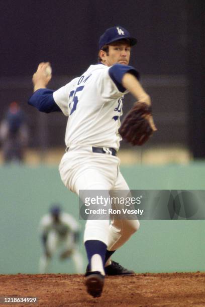Tommy John of the Los Angeles Dodgers pitches during an MLB game at Dodger Stadium in Los Angeles, California. John played for 26 seasons with 6...