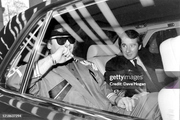 Elton John and manager John Reid in London in May 1984