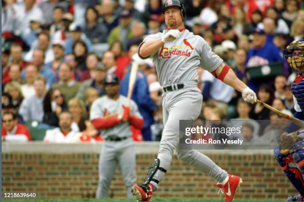 Mark McGwire of the St. Louis Cardinals bats during an MLB game at Wrigley Field in Chicago, Illinois. McGwire played for 16 seasons with 2 different...