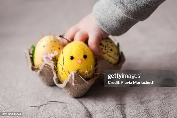 baby's hand over easter decoration - baby chicken bildbanksfoton och bilder