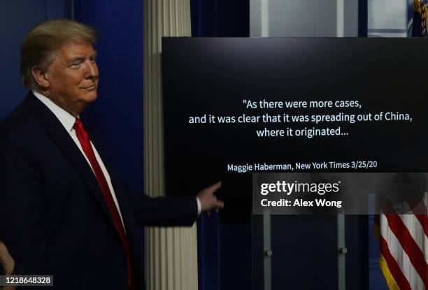 President Donald Trump stands next to a monitor playing a video during the briefing of the White House Coronavirus Task Force in the James Brady...