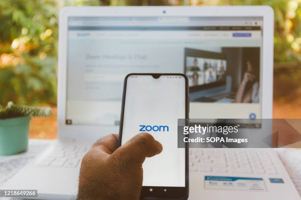 In this photo illustration a Zoom Video Communications logo is displayed on a smartphone.