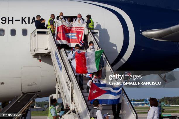 The first Cuban medical brigade of the 'Henry Reeve' Contingent coming from Italy arrive at the Jose Marti International Airport in Havana on June 8,...