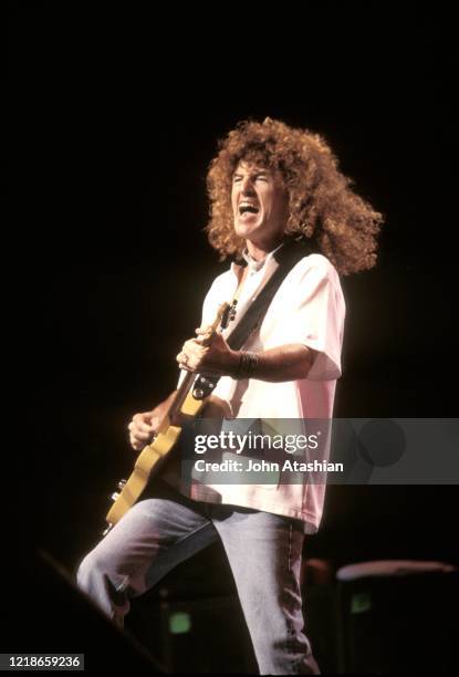 Singer, songwriter and guitarist Kevin Cronin is shown performing on stage during a "live' concert appearance with REO Speedwagon on July 1, 1990.