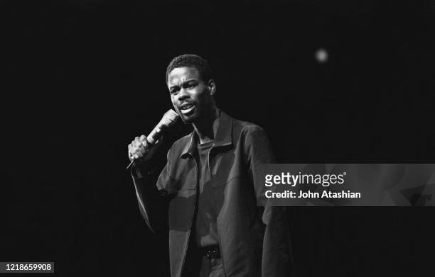 Comedian and actor Chris Rock is shown performing on stage during a "live" concert appearance on February 11, 1999.