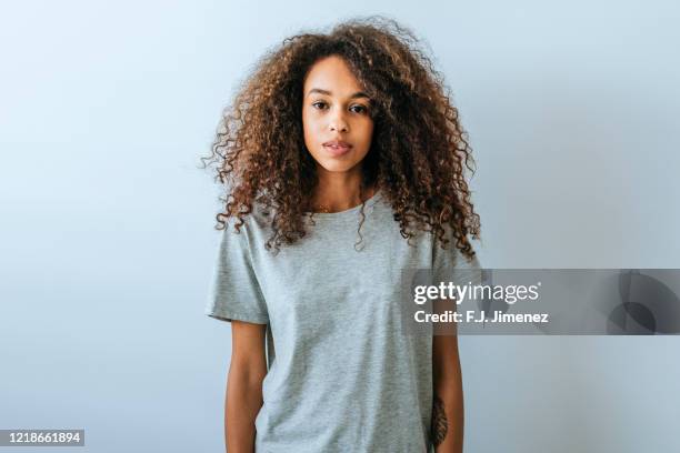 portrait of woman with afro hair with white wall background - natural portrait studio shot white background stock pictures, royalty-free photos & images
