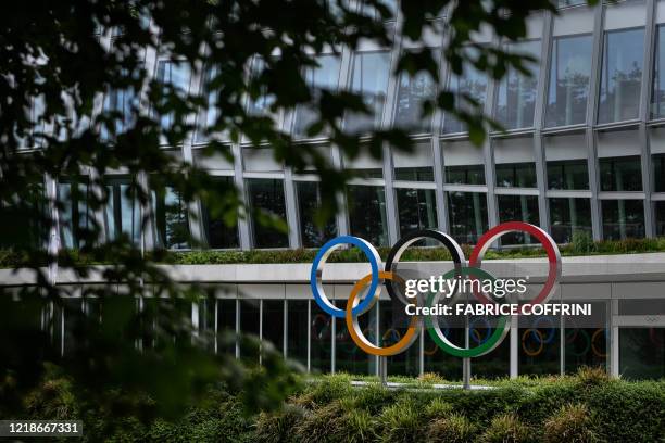 Picture taken on June 8, 2020 shows the Olympic rings logo at the entrance of the headquarters of the International Olympic Committee in Lausanne...