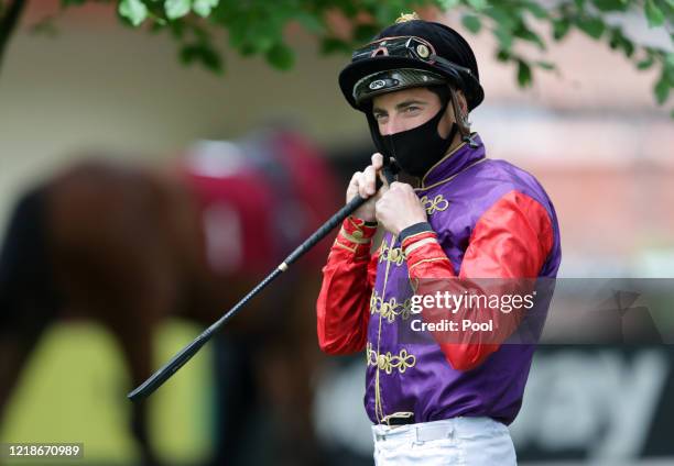 Jockey, James Doyle wears a face mask before the Read Andrew Balding On Betway Insider EBF Maiden Stakes at Haydock Racecourse on June 09, 2020 in...