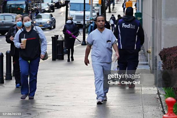 Medical staff arrive for their shift at NewYork-Presbyterian Hospital/Weill Cornell Medical Center during the coronavirus pandemic on April 13, 2020...