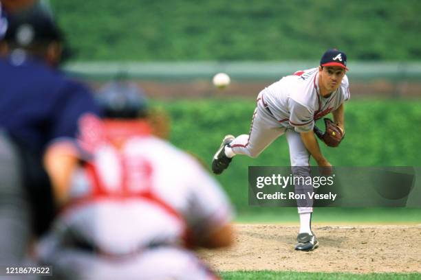Greg Maddux of the Atlanta Braves pitches during an MLB game at Wrigley Field in Chicago, Illinois. Maddux played for 23 years with 4 different teams...