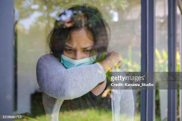 asian woman covering cough into elbow - covering cough stock pictures, royalty-free photos & images