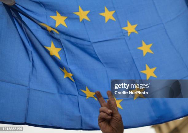 Member of the Committee for the Defence of Democracy holds a an EU flag, during the 'Support for Judge Igor Tuley' protest organised in Krakow's Main...