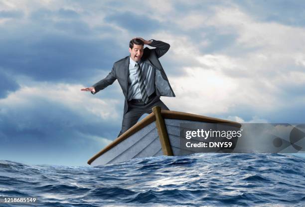 businessman balancing in boat in rough seas - falling behind stock pictures, royalty-free photos & images