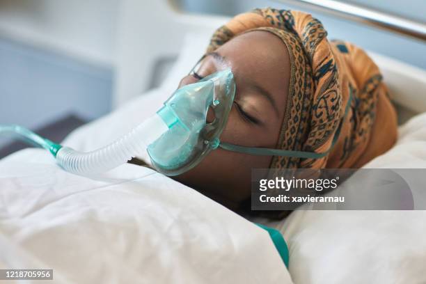 teenage african female hospital patient with oxygen mask - africa hospital stock pictures, royalty-free photos & images