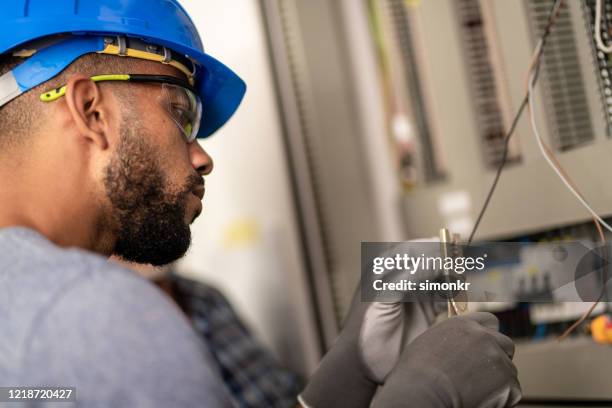 electrician cutting wire - blue glove stock pictures, royalty-free photos & images