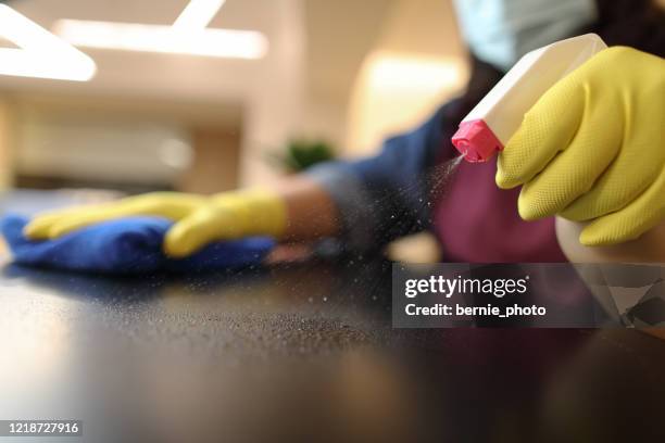 woman wearing gloves cleaning desktop - office cleaning stock pictures, royalty-free photos & images