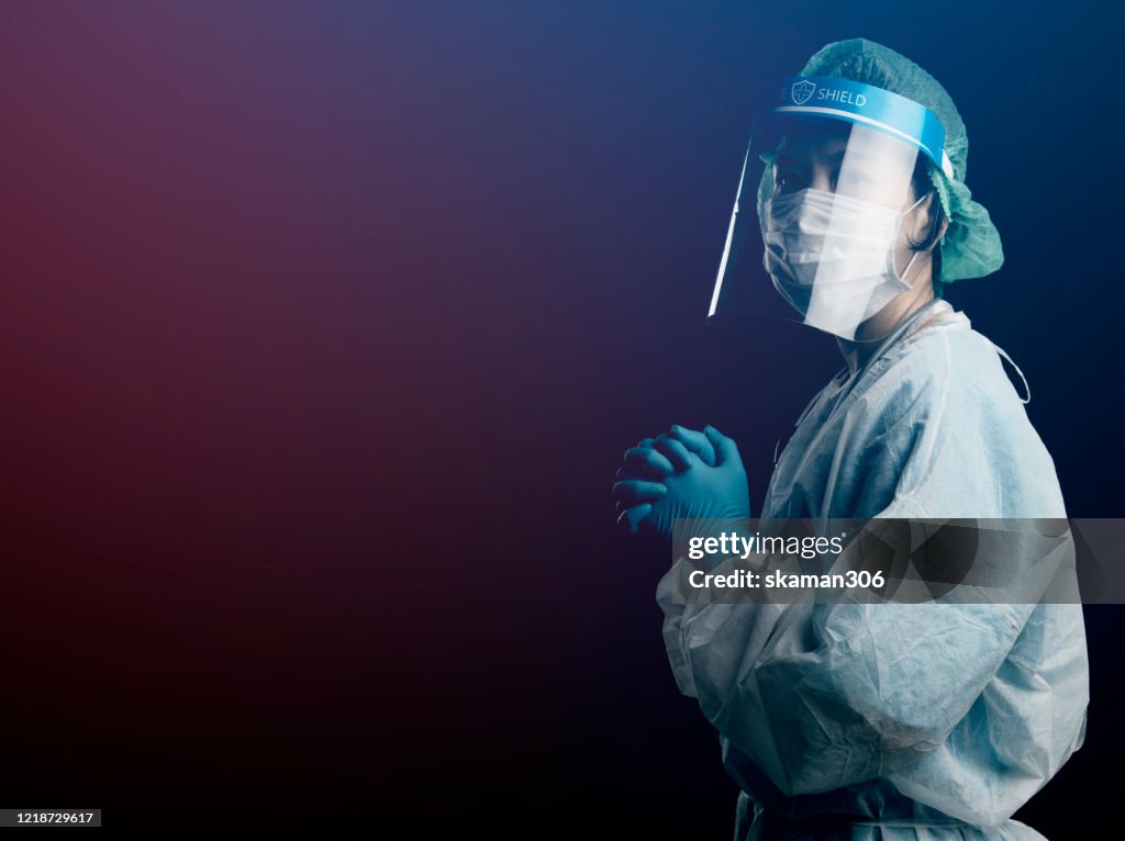 Doctor in PPE suit uniform has stress and pray in Coronavirus outbreak or Covid-19, Concept of Covid-19 quarantine.Emotional stress of overworked doctor and medical care team during covid-10 period.