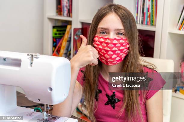 girl sewing surgical mask - homemade face mask isolated stock pictures, royalty-free photos & images