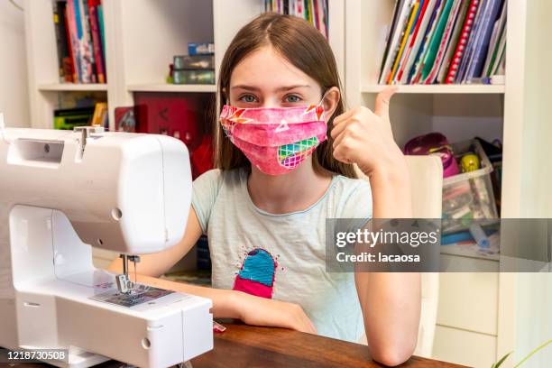 girl sewing surgical mask - homemade face mask isolated stock pictures, royalty-free photos & images