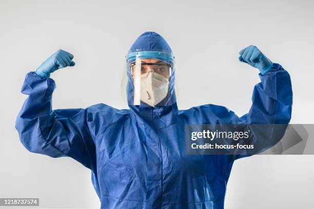 strong doctor during coronavirus covid 19 novel corona virus outbreak - surgical glove stock pictures, royalty-free photos & images