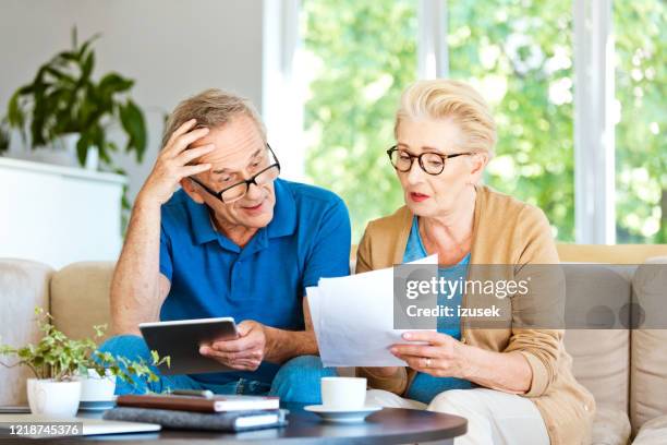 senior couple working out a home budget - invoice stock pictures, royalty-free photos & images