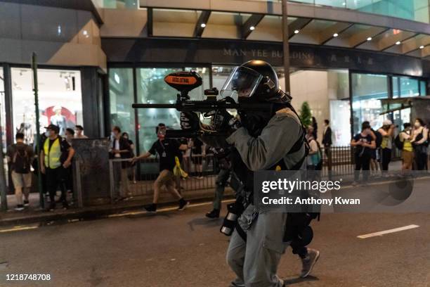 Riot police uses pepper-spray projectile to disperse protesters during a rally in Central district on June 9, 2020 in Hong Kong, China. The city...