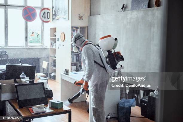 disinfecting office work space - social distancing in office stock pictures, royalty-free photos & images