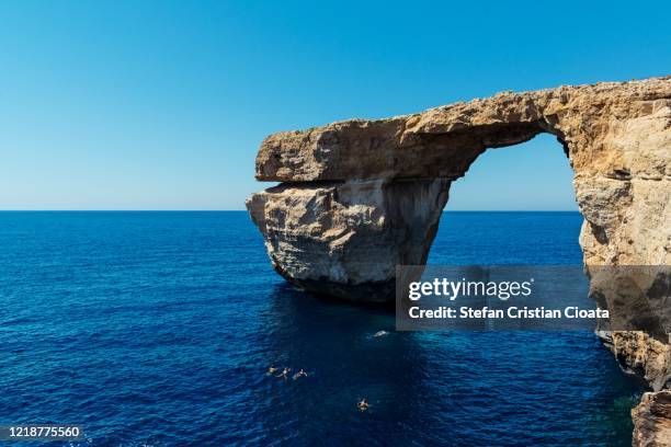 azure window - limestone natural arch on the maltese island of gozo - azure window malta stock pictures, royalty-free photos & images