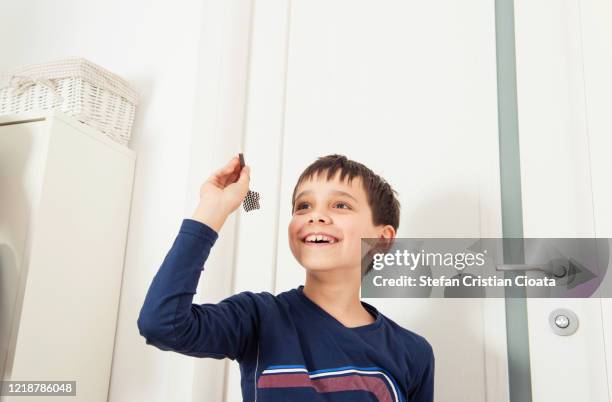 boy playing darts at home - throwing darts stock pictures, royalty-free photos & images
