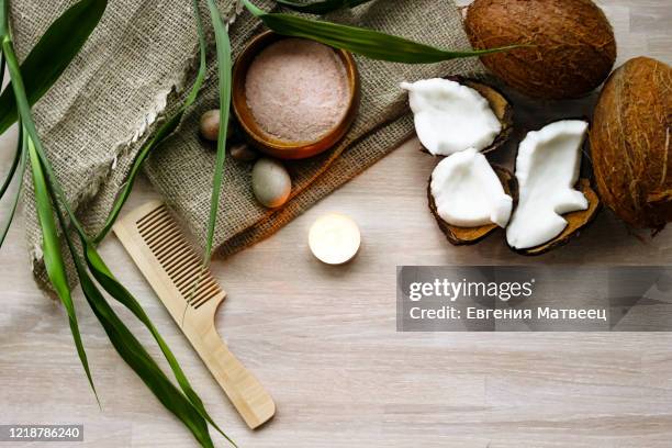 bath, spa concept, salt, coconut, lighting candle, linen towel, haircomb on wooden background - badewanne mit obst stock-fotos und bilder