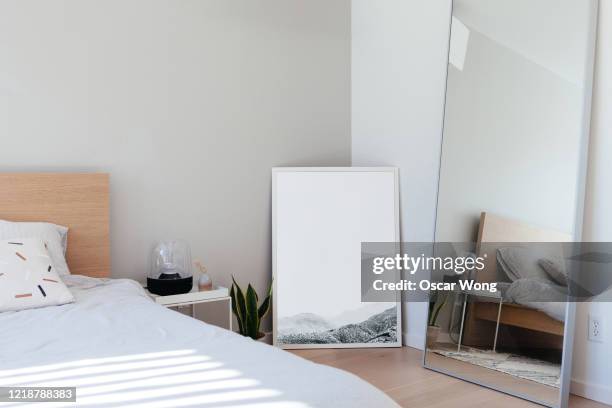 a modern, minimal and stylish bedroom with sunlight - bedroom mirror stock-fotos und bilder