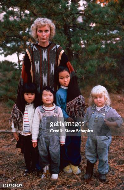 Portrait of American actress Mia Farrow as she poses outdoors with her children, Martha's Vineyard, Massachusetts, 1979. Pictured are, fore from...
