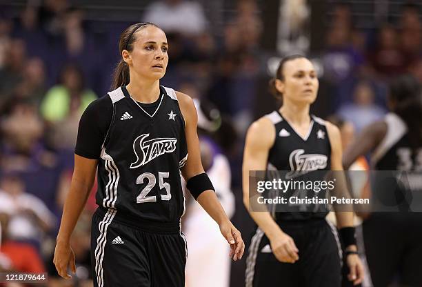 Becky Hammon and Tully Bevilaqua of the San Antonio Silver Stars walk back to their bench during the WNBA game against the Phoenix Mercury at US...