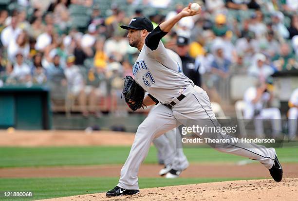 Luis Perez of the Toronto Blue Jays pitches against the Oakland Athletics during an MLB baseball game August 21, 2011 at the O.co Coliseum in...