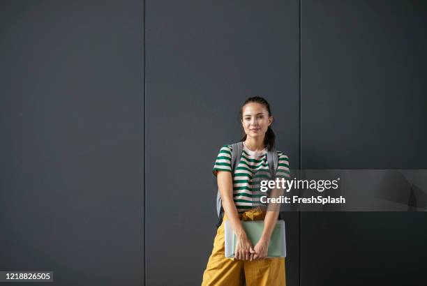 portrait of a happy college student - holding laptop stock pictures, royalty-free photos & images