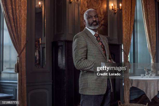 portrait of a black vintage country gentleman alone in a stately home - african ethnicity luxury stock pictures, royalty-free photos & images
