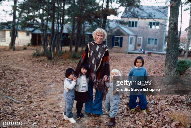 Portrait of American actress Mia Farrow as she poses outdoors with her children, Martha's Vineyard, Massachusetts, 1979. Pictured are, fore from...
