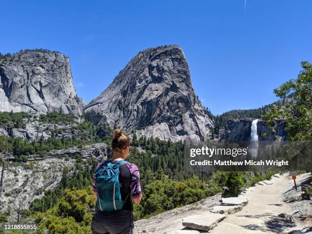 a girl hikes to vernal falls in yosemite. - バーナル滝 ストックフォトと画像