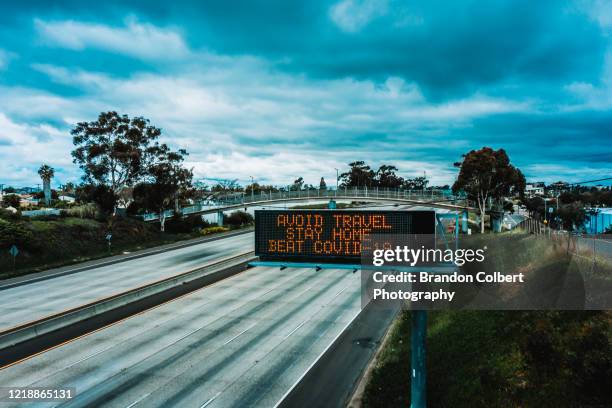 covid-19 pandemic, freeway message - stay at home order stock pictures, royalty-free photos & images