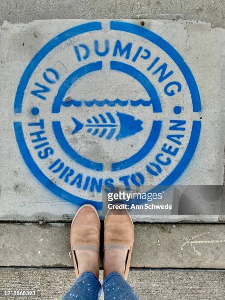 no dumping in our ocean. - kerb stock pictures, royalty-free photos & images