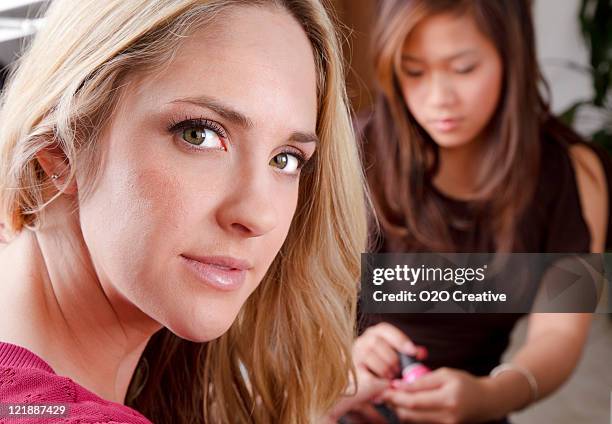 woman getting a manicure - manicure stockfoto's en -beelden