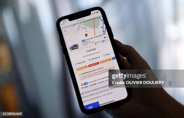 This illustration picture shows Google map application displaying popular times for transit station and how busy it is at the moment on a smartphone...