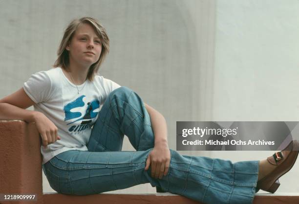 American child actress Jodie Foster, wearing a t-shirt with the Gitanes logo, April 1976.