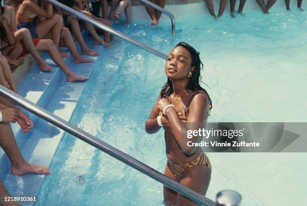 American actress and singer Tatyana Ali standing in a swimming pool, 1993.