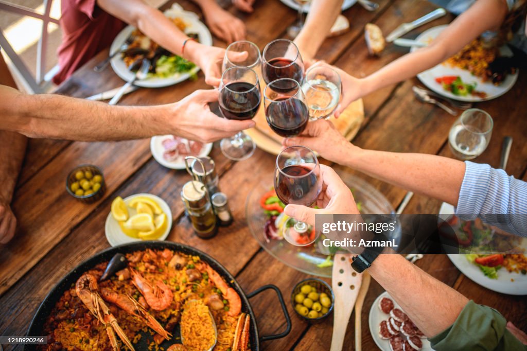 Toasting with Red Wine and Water Before Start of Midday Meal