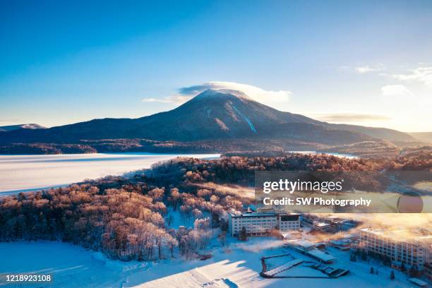 beautiful morning in akan lake and mountain oakan - japan snow stockfoto's en -beelden