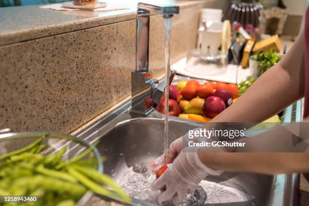 disinfecting groceries during covid-19 - safety stock pictures, royalty-free photos & images