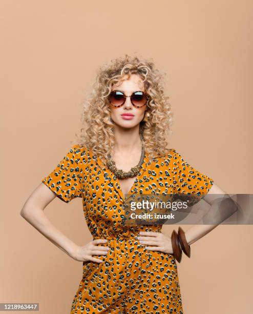 fashion portrait of woman in leopard print dress - fashion orange colour stock pictures, royalty-free photos & images