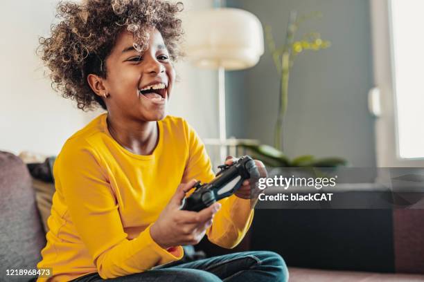 young girl playing video games - quarantine fun stock pictures, royalty-free photos & images