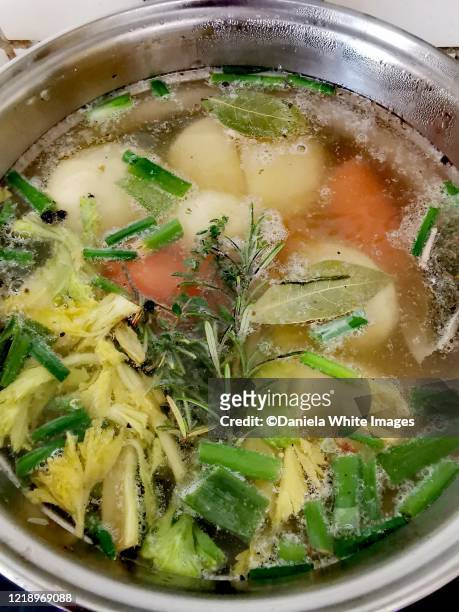 making chicken bone broth - bouillon stock pictures, royalty-free photos & images